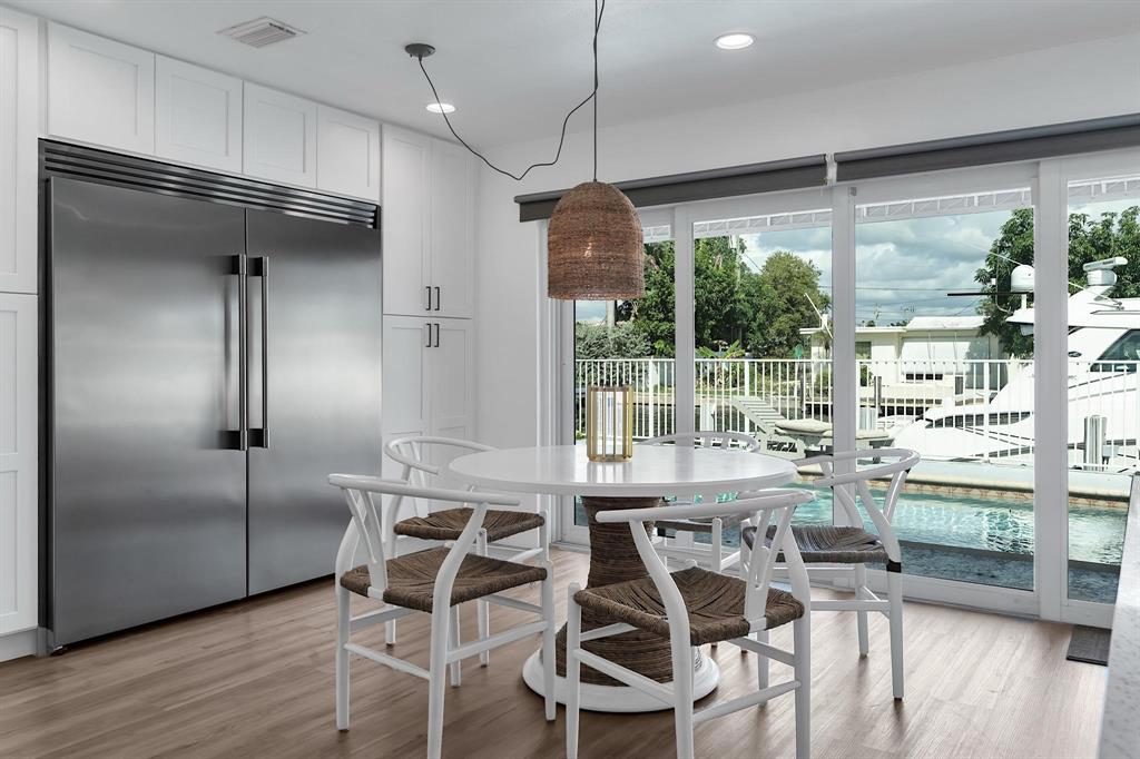 2233 Southeast 15th Street Pompano Beach, FL 33062 - Photo 23 of 53 a view of a dining room with furniture large windows and wooden floor