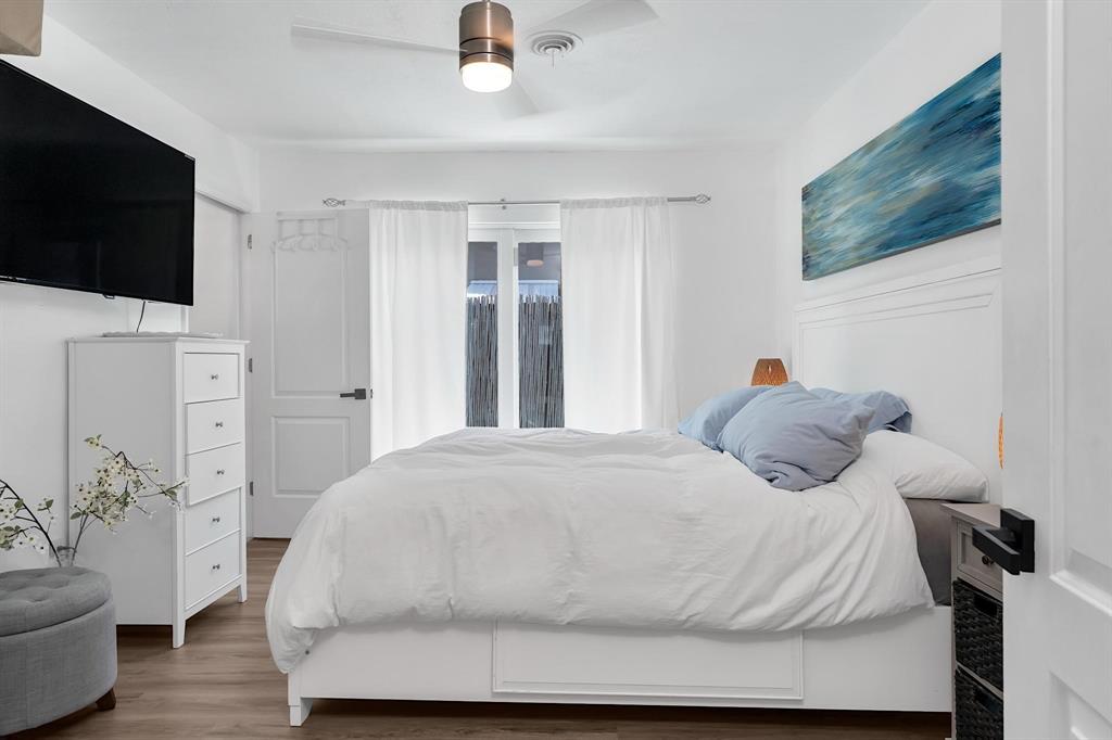 2233 Southeast 15th Street Pompano Beach, FL 33062 - Photo 34 of 53 a bedroom with a bed and a flat screen tv