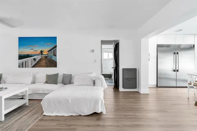 a bedroom with a bed a flat screen tv and a couch