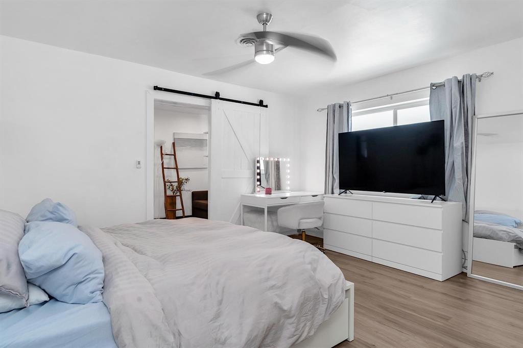 2233 Southeast 15th Street Pompano Beach, FL 33062 - Photo 41 of 53 a bedroom with a bed and a flat screen tv