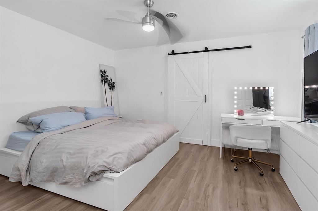 2233 Southeast 15th Street Pompano Beach, FL 33062 - Photo 43 of 53 a bedroom with a bed and a table in it