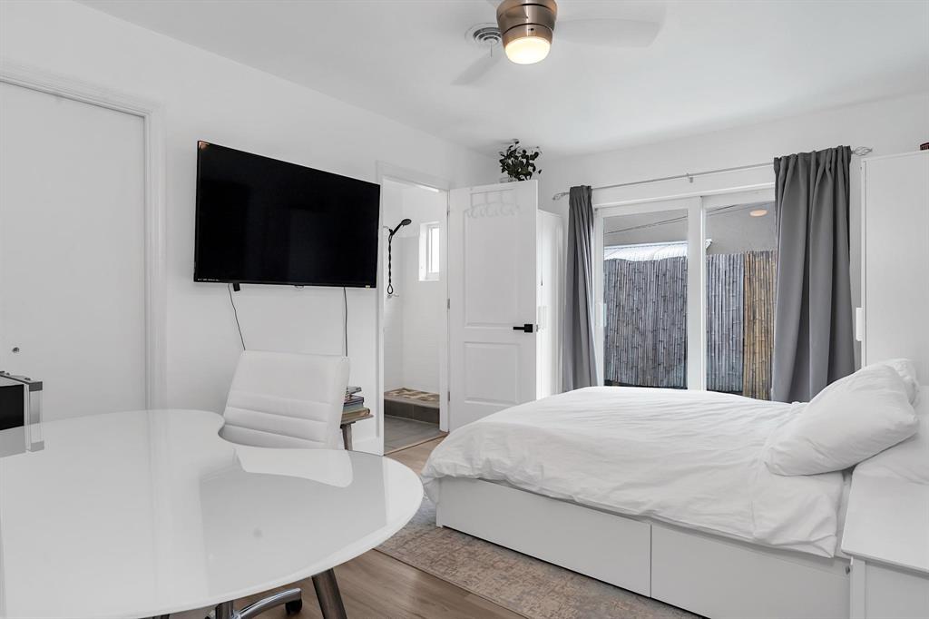 2233 Southeast 15th Street Pompano Beach, FL 33062 - Photo 48 of 53 a bedroom with a bed a flat screen tv and a couch