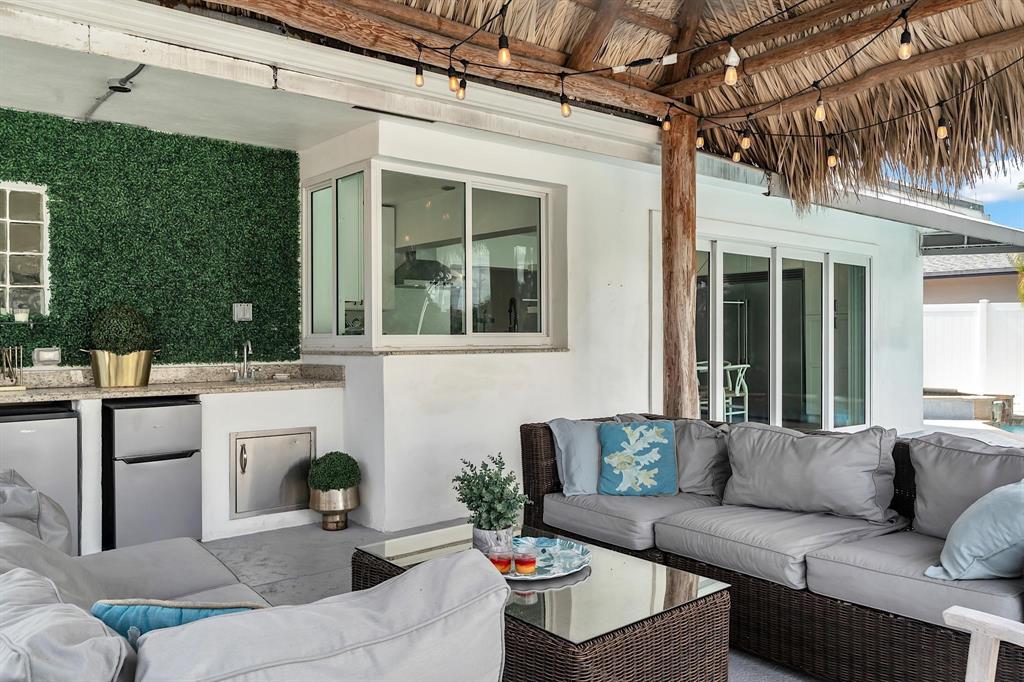 2233 Southeast 15th Street Pompano Beach, FL 33062 - Photo 5 of 53 a view of a patio with couches table and chairs and potted plants