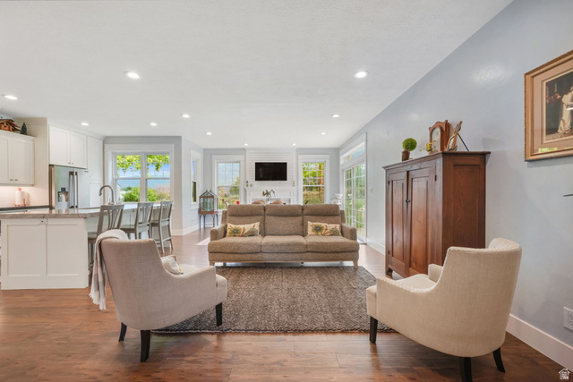 357 South 320 W Street Lindon, UT 84042 - Photo 4 of 41 Open-concept living area featuring rich wood-finish flooring, recessed lighting, and a white kitchen with a peninsula island