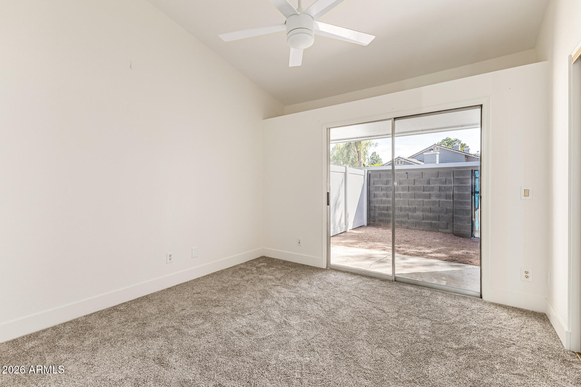 860 North McQueen Road, Unit 1092 Chandler, AZ 85225 - Photo 15 of 26 an empty room with a fireplace and windows