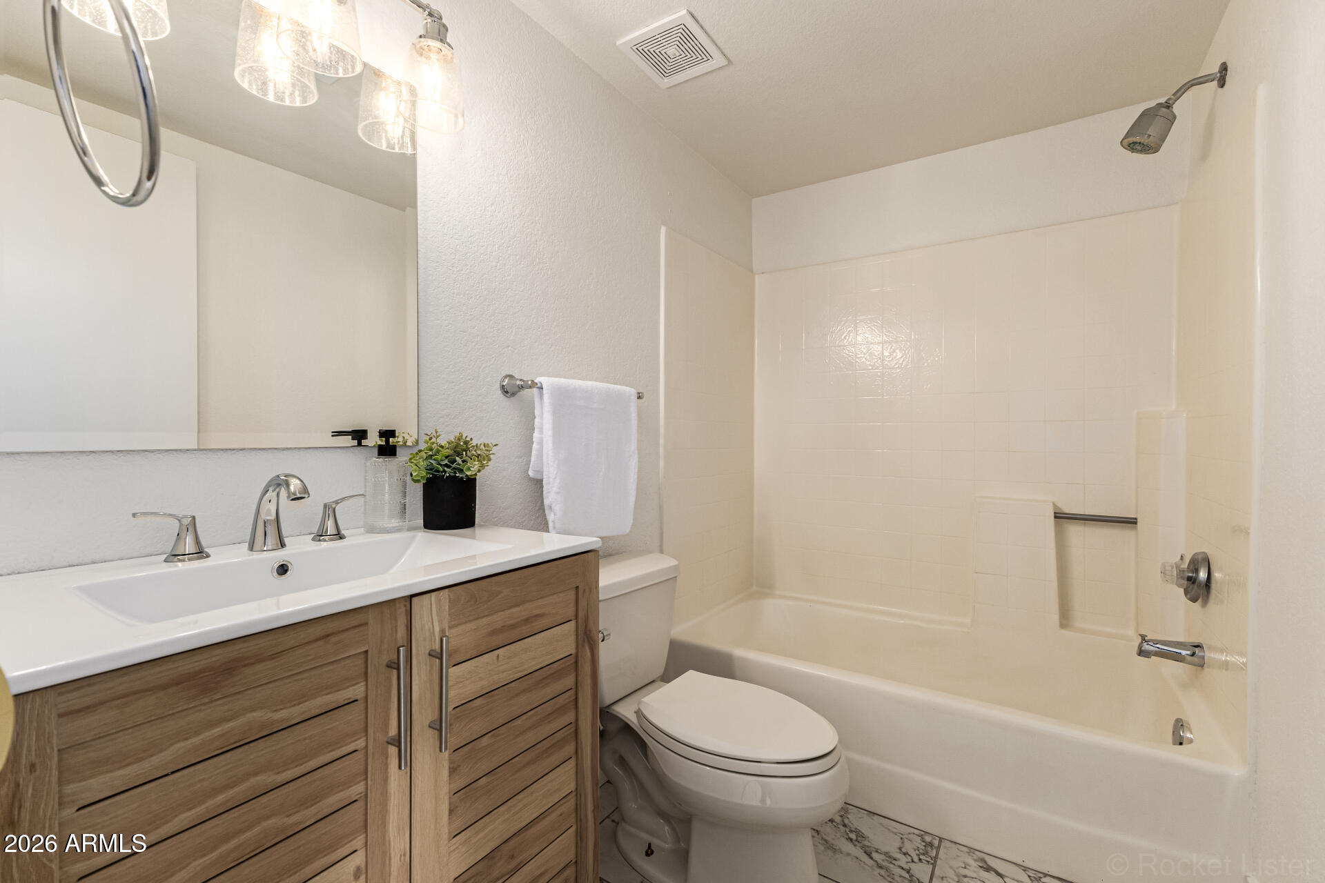 860 North McQueen Road, Unit 1092 Chandler, AZ 85225 - Photo 18 of 26 a bathroom with a sink a toilet and shower