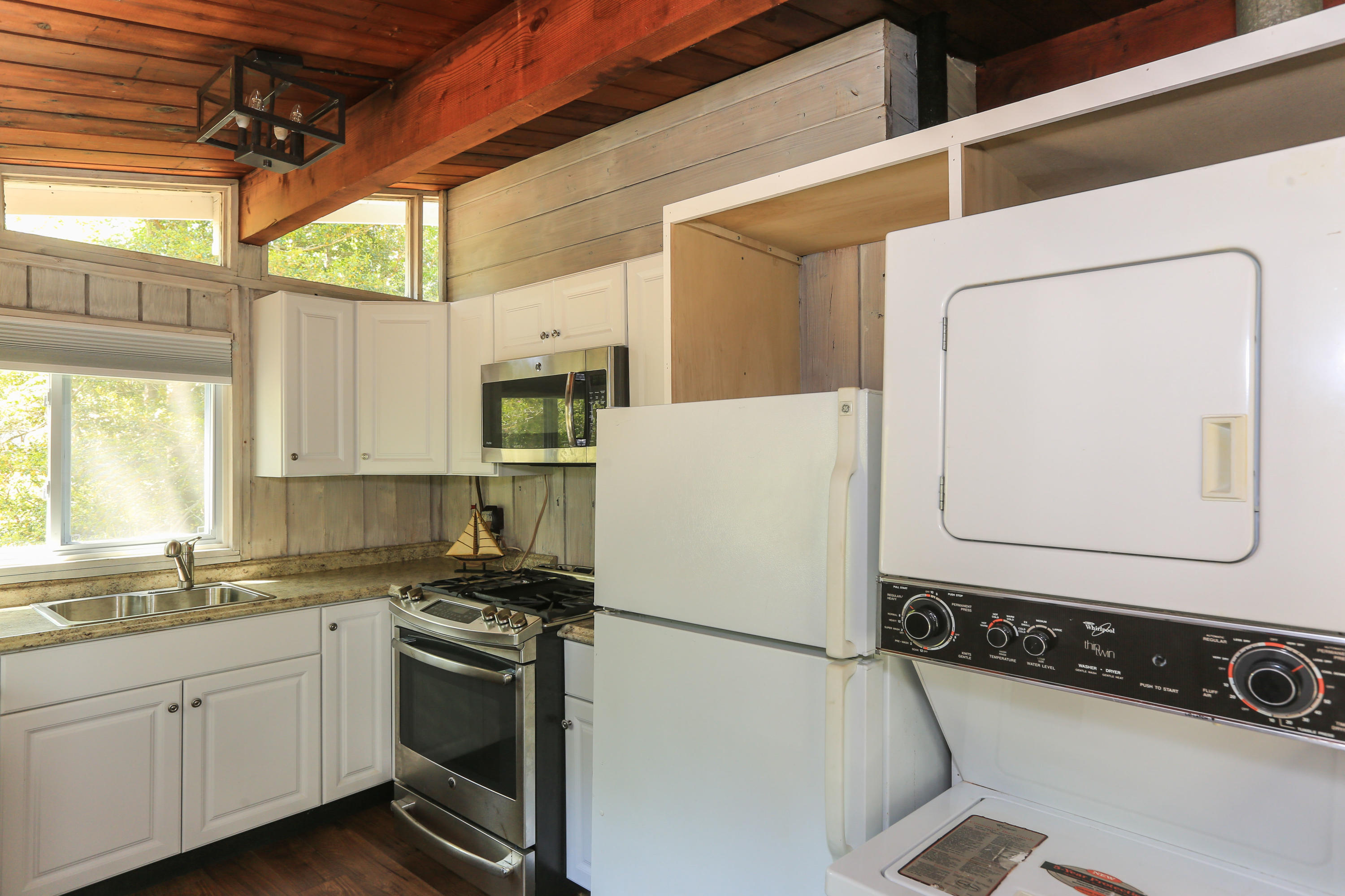 38 Lakeside Drive Marstons Mills, MA 02648 - Photo 4 of 21 a kitchen with a refrigerator a sink and white cabinets
