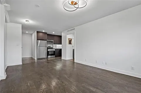 a view of kitchen with refrigerator and window