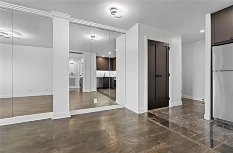 a view of a hallway with wooden shelves