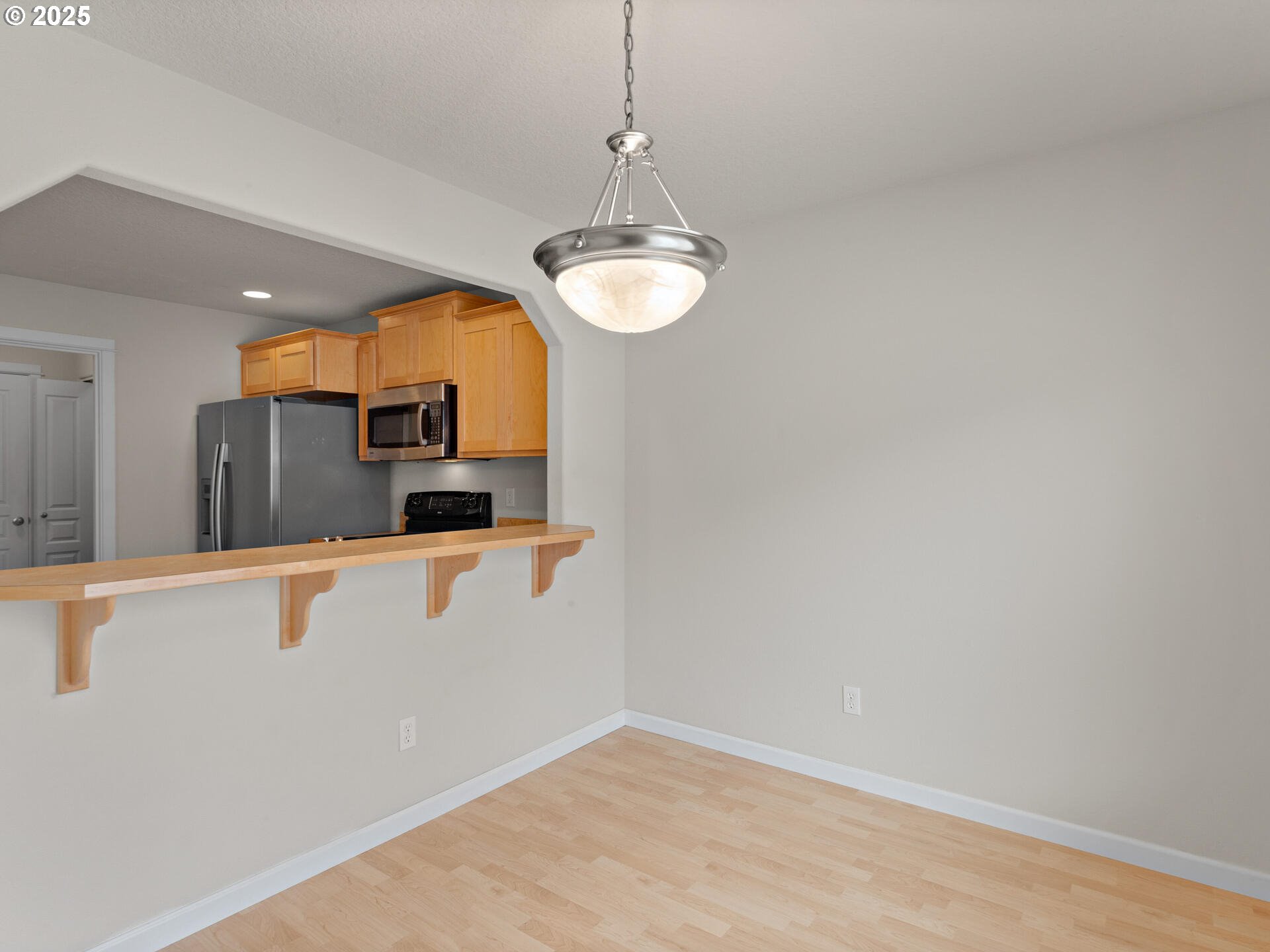 2709 Fletch Street Forest Grove, OR 97116 - Photo 14 of 44 a view of kitchen with stainless steel appliances granite countertop cabinets and a wooden floor