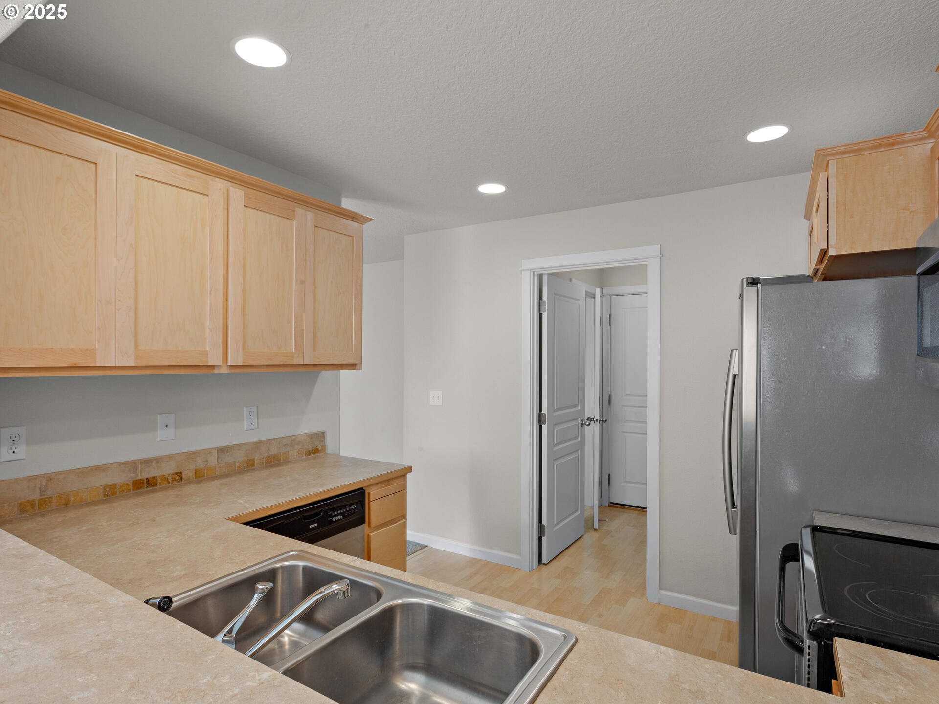2709 Fletch Street Forest Grove, OR 97116 - Photo 17 of 44 a kitchen with stainless steel appliances granite countertop a refrigerator and a sink