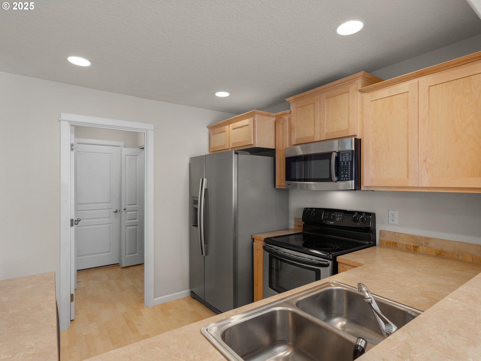 2709 Fletch Street Forest Grove, OR 97116 - Photo 18 of 44 a kitchen with stainless steel appliances a refrigerator a sink a stove a microwave and cabinets