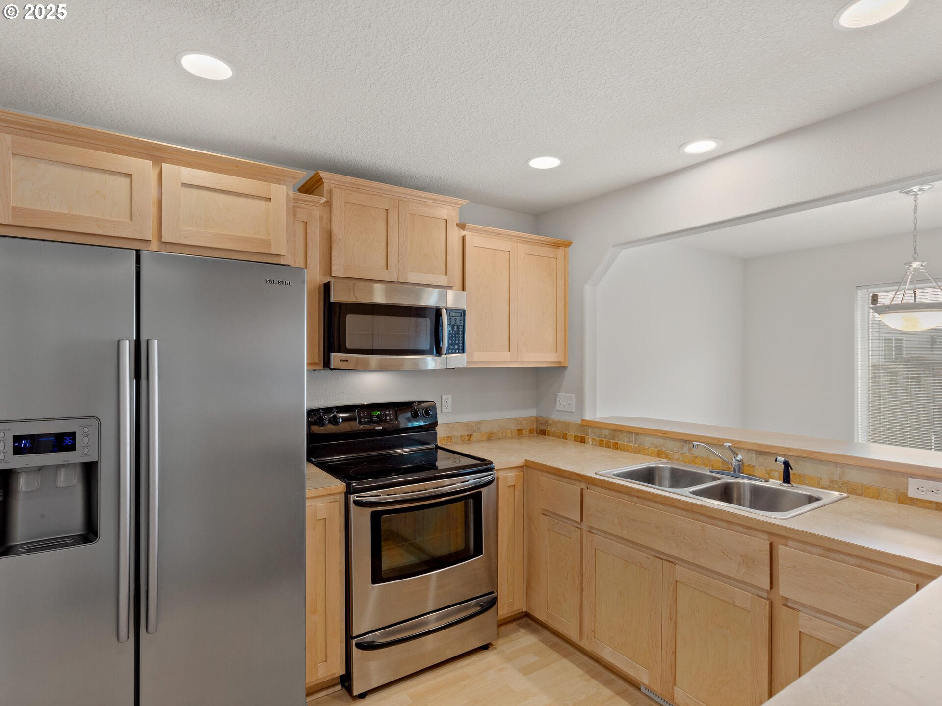 2709 Fletch Street Forest Grove, OR 97116 - Photo 19 of 44 a kitchen with stainless steel appliances white cabinets and a sink