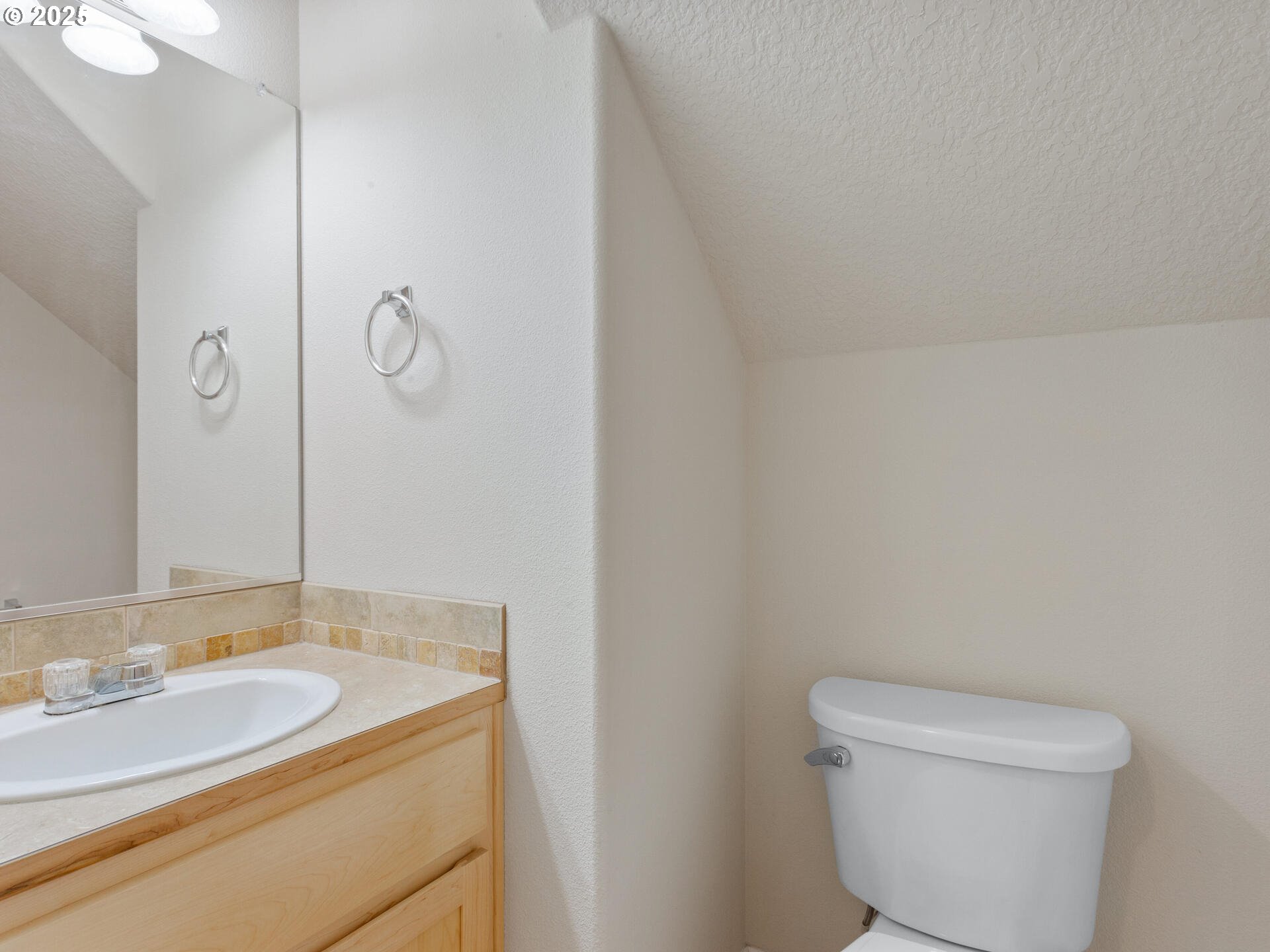 2709 Fletch Street Forest Grove, OR 97116 - Photo 23 of 44 a bathroom with a granite countertop sink a toilet and a mirror