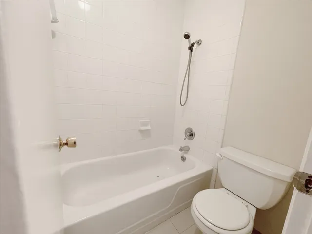 a bathroom with a toilet and a bath tub