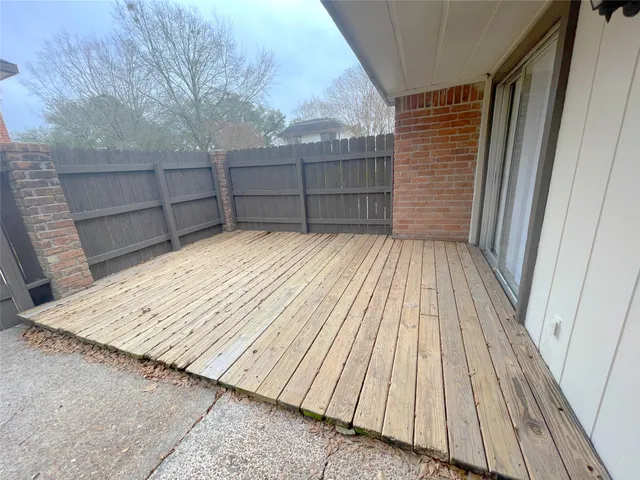 a view of wooden floor with a wooden fence
