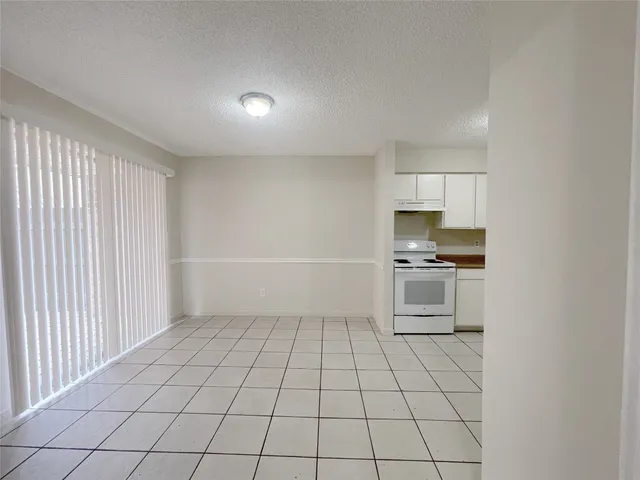 a view of kitchen with microwave and cabinets