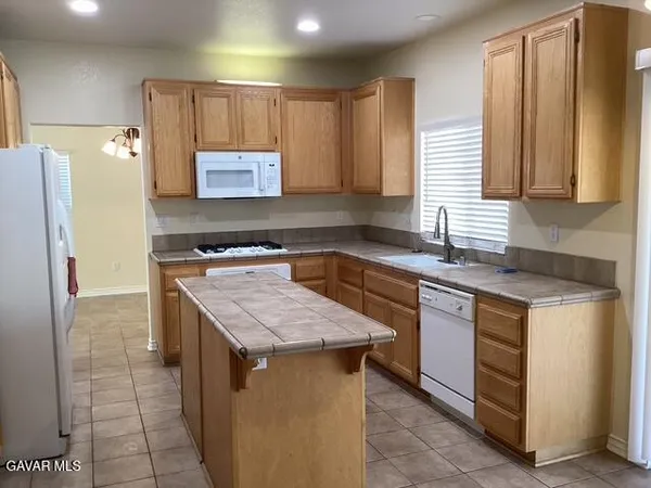 a kitchen with a sink stove and refrigerator