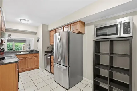 a kitchen with stainless steel appliances granite countertop a refrigerator and a stove top oven
