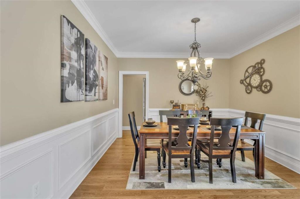 1611 Silvergrass Lane Grayson, GA 30017 - Photo 11 of 90 a view of a dining room with furniture a chandelier and wooden floor