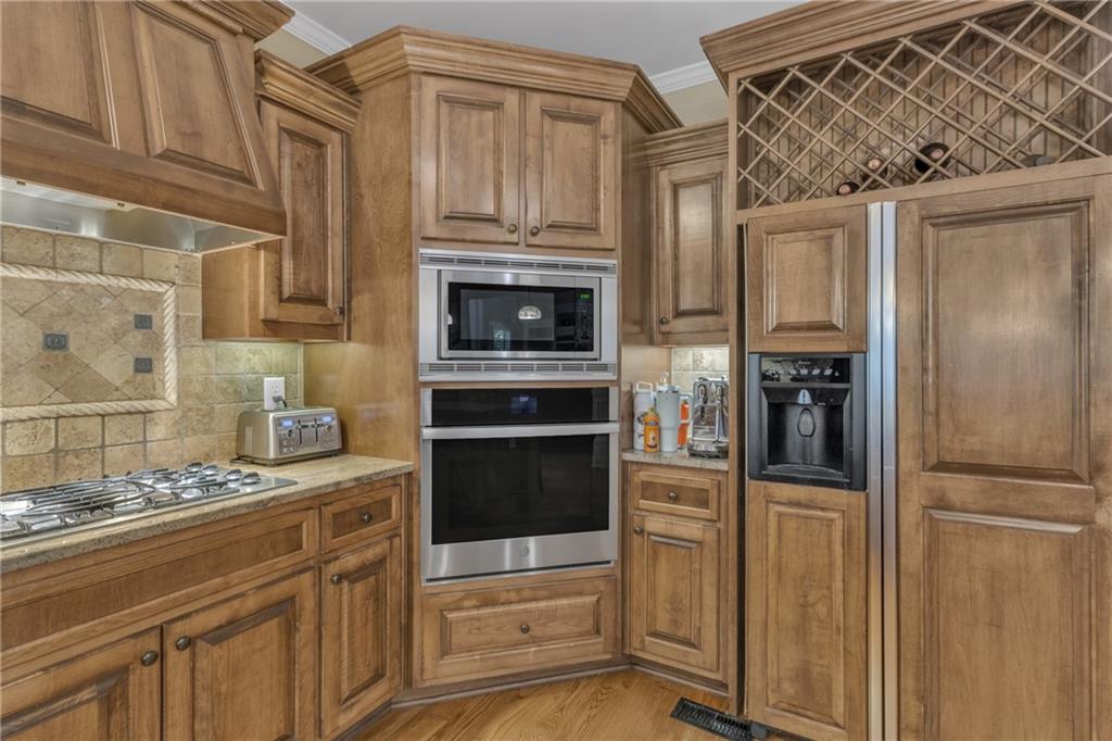 1611 Silvergrass Lane Grayson, GA 30017 - Photo 13 of 90 a kitchen with stainless steel appliances granite countertop a refrigerator and a stove