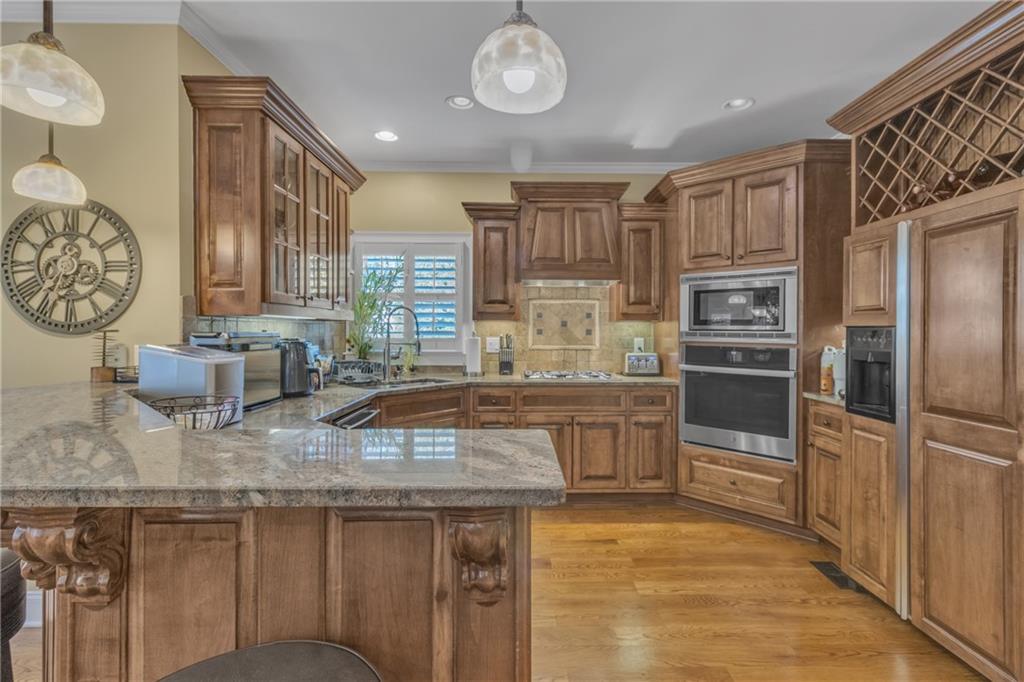 1611 Silvergrass Lane Grayson, GA 30017 - Photo 15 of 90 a kitchen with stainless steel appliances granite countertop a stove a sink and a refrigerator