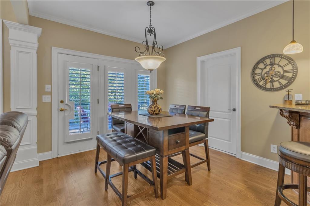 1611 Silvergrass Lane Grayson, GA 30017 - Photo 18 of 90 a dining room with furniture a chandelier and wooden floor