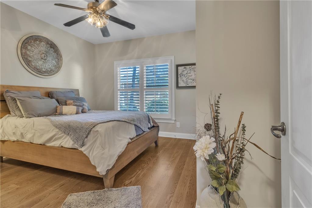 1611 Silvergrass Lane Grayson, GA 30017 - Photo 25 of 90 a bedroom with a bed and a chandelier