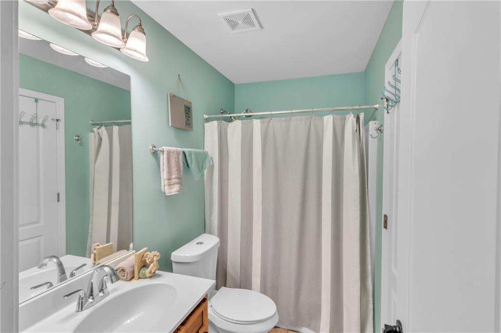 1611 Silvergrass Lane Grayson, GA 30017 - Photo 48 of 90 a bathroom with a sink a toilet and shower curtain