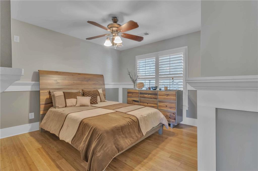 1611 Silvergrass Lane Grayson, GA 30017 - Photo 50 of 90 a bedroom with a large bed and a chandelier