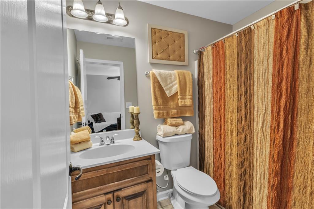 1611 Silvergrass Lane Grayson, GA 30017 - Photo 56 of 90 a bathroom with a toilet a sink and a mirror