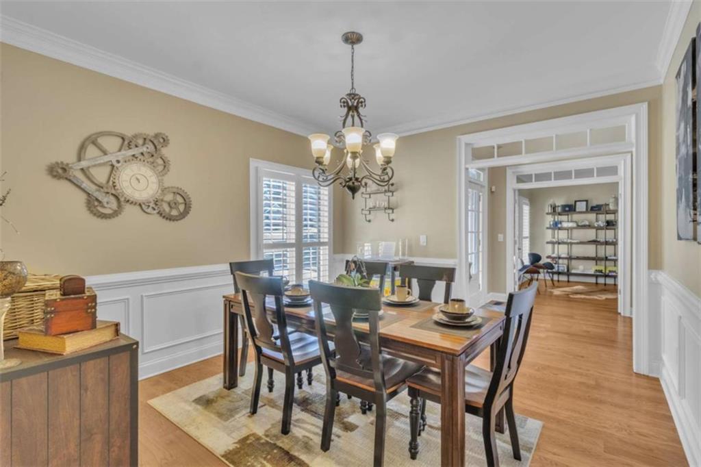 1611 Silvergrass Lane Grayson, GA 30017 - Photo 10 of 90 a view of a dining room with furniture wooden floor and a chandelier
