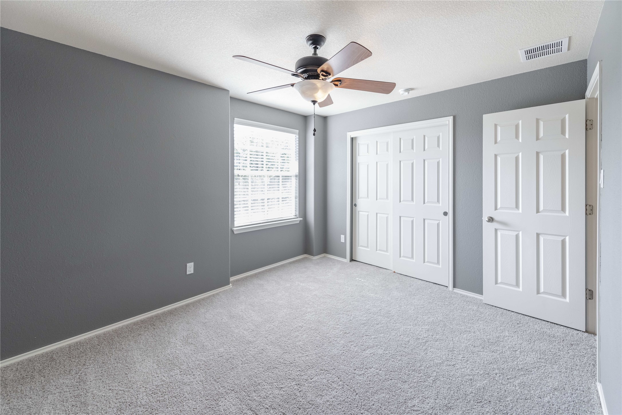 11221 Old Quarry Road Austin, TX 78717 - Photo 10 of 19 Plush carpeting and a classic window create a cozy ambiance in this bedroom.