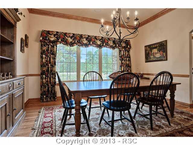 11587 Shaugnessy Road Colorado Springs, CO 80908 - Photo 8 of 24 Formal dining area with crown molding