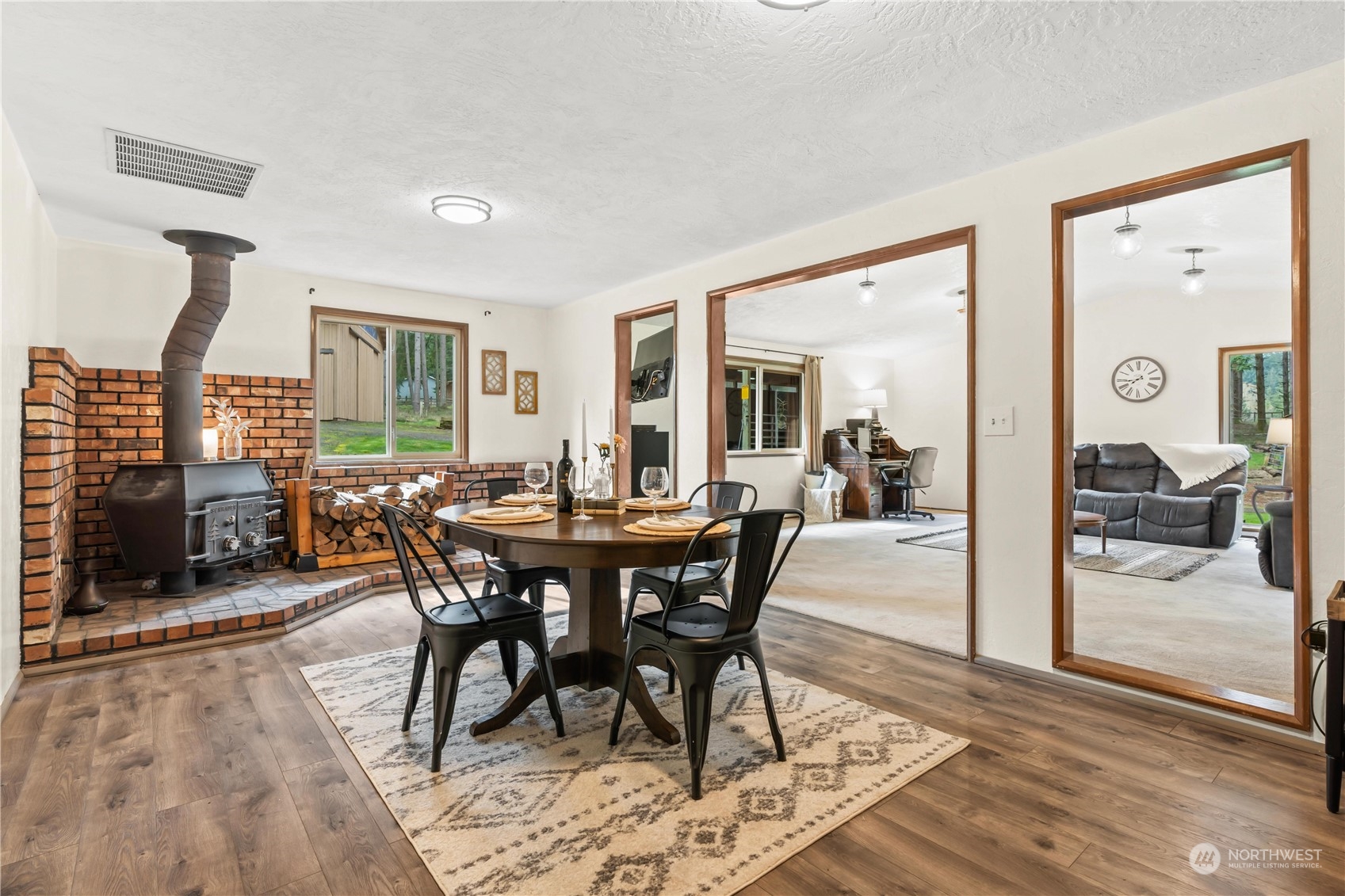 174 Frogner Road Chehalis, WA 98532 - Photo 11 of 40 a view of a dining room and livingroom with furniture wooden floor and a rug