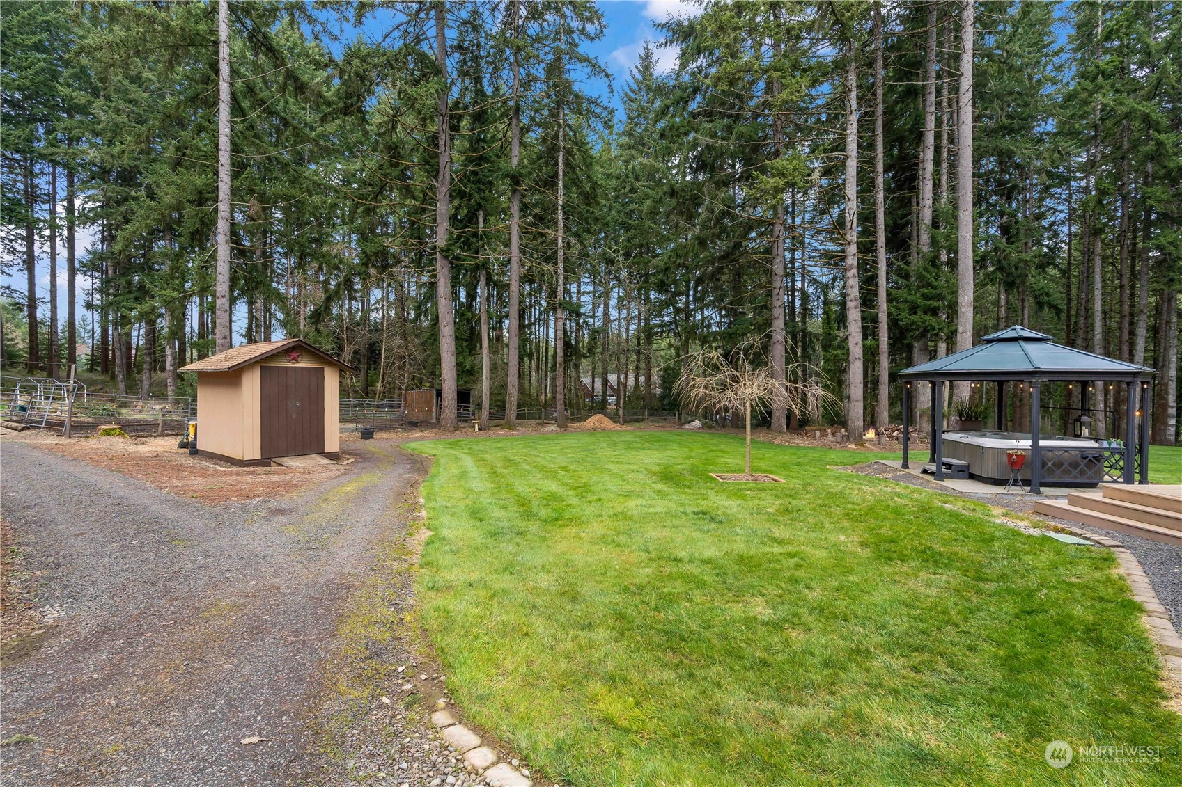 174 Frogner Road Chehalis, WA 98532 - Photo 27 of 40 a view of a backyard with table and chairs under an umbrella