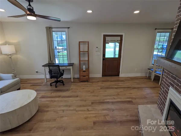 a living room with furniture and a wooden floor