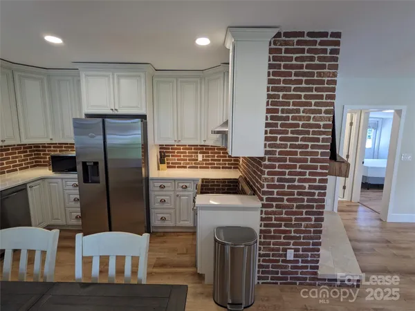 a kitchen with a refrigerator and a stove