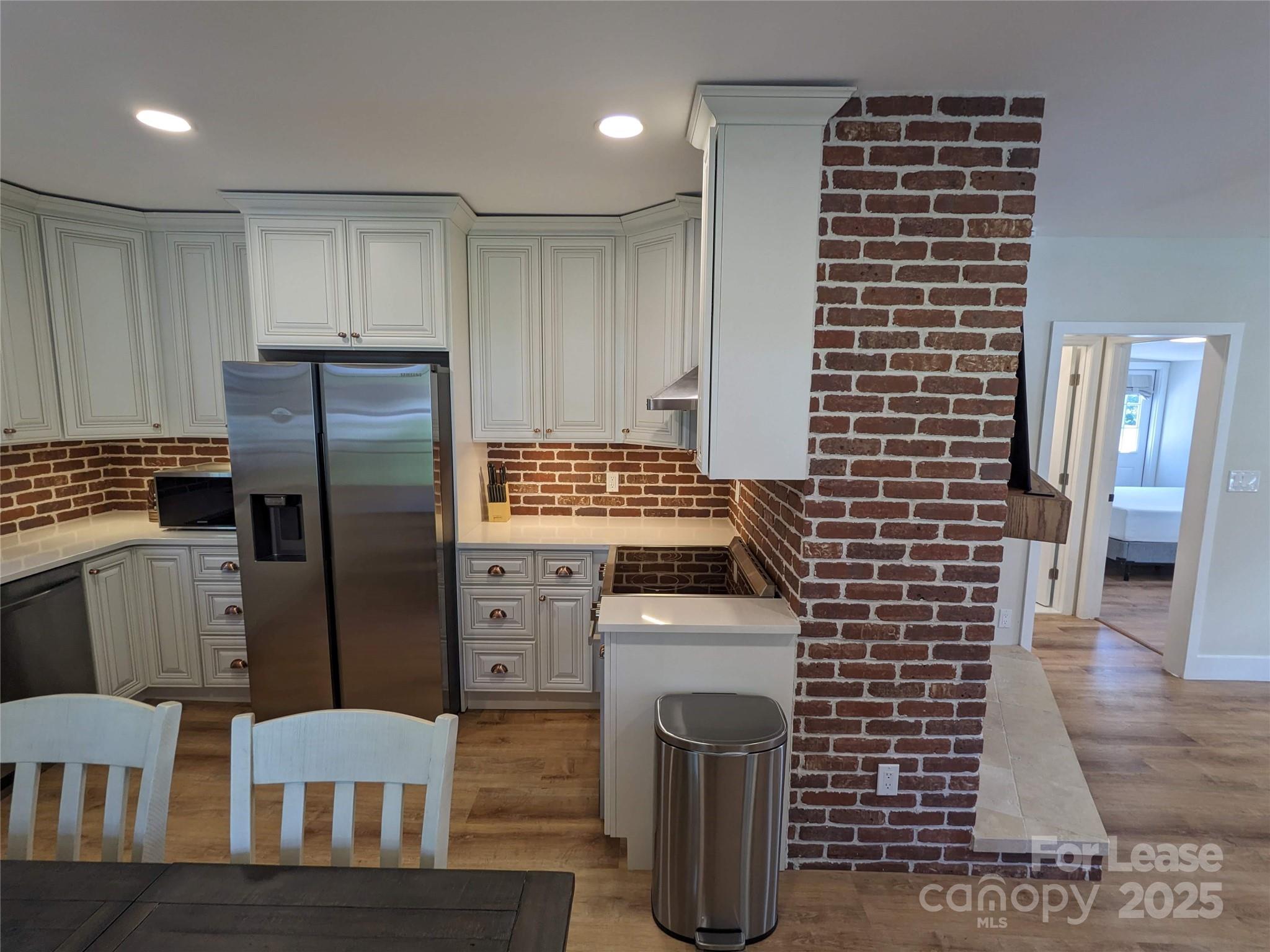 29 Woodrow Avenue, Unit 1 Asheville, NC 28801 - Photo 2 of 23 a kitchen with a refrigerator and a stove
