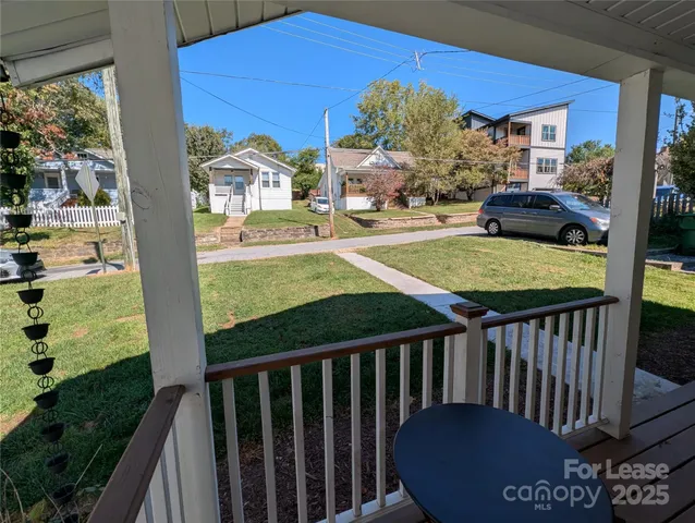 a view of a balcony with yard