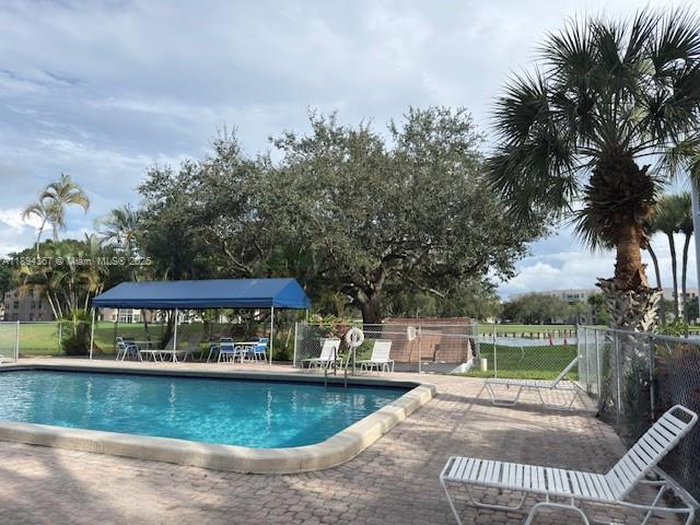 9441 Live Oak Place, Unit 207 Davie, FL 33324 - Photo 18 of 24 a view of a swimming pool with a patio