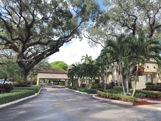 9441 Live Oak Place, Unit 207 Davie, FL 33324 - Photo 21 of 24 a front view of a house with a garden and trees
