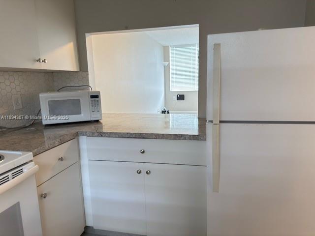 9441 Live Oak Place, Unit 207 Davie, FL 33324 - Photo 7 of 24 a bathroom with a granite countertop sink and white cabinets