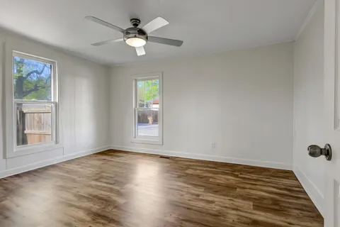wooden floor in an empty room with a window