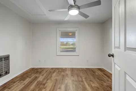 wooden floor in an empty room with a window