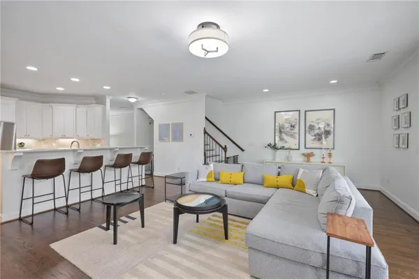 a living room with furniture and kitchen view