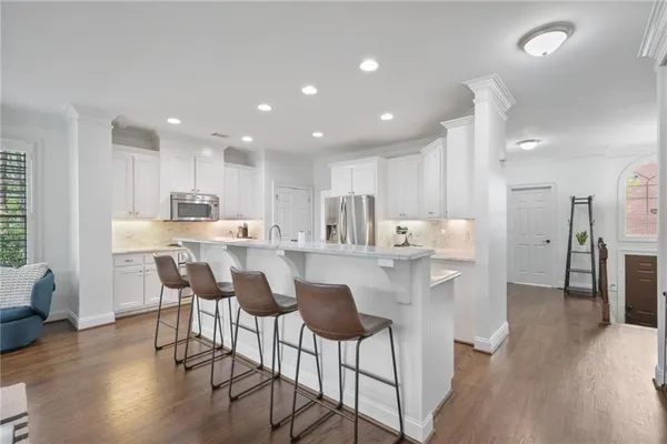a kitchen with kitchen island wooden cabinets and stainless steel appliances