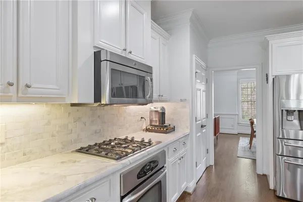 a kitchen with stainless steel appliances granite countertop a stove and a refrigerator
