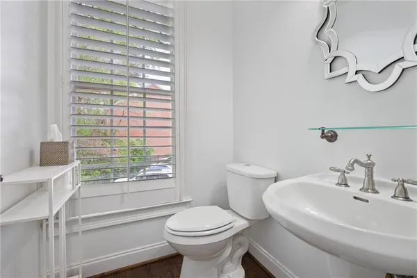 a white toilet sitting next to a bathroom sink