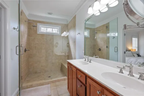 a bathroom with a double vanity sink mirror and shower